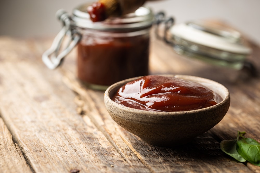 A small ramekin of bbq sauce.