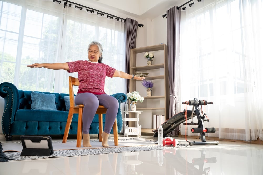 Woman woking out in her chair.
