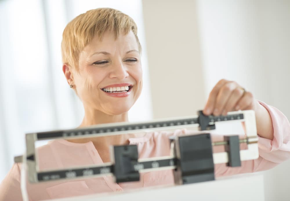 Happy woman on a scale